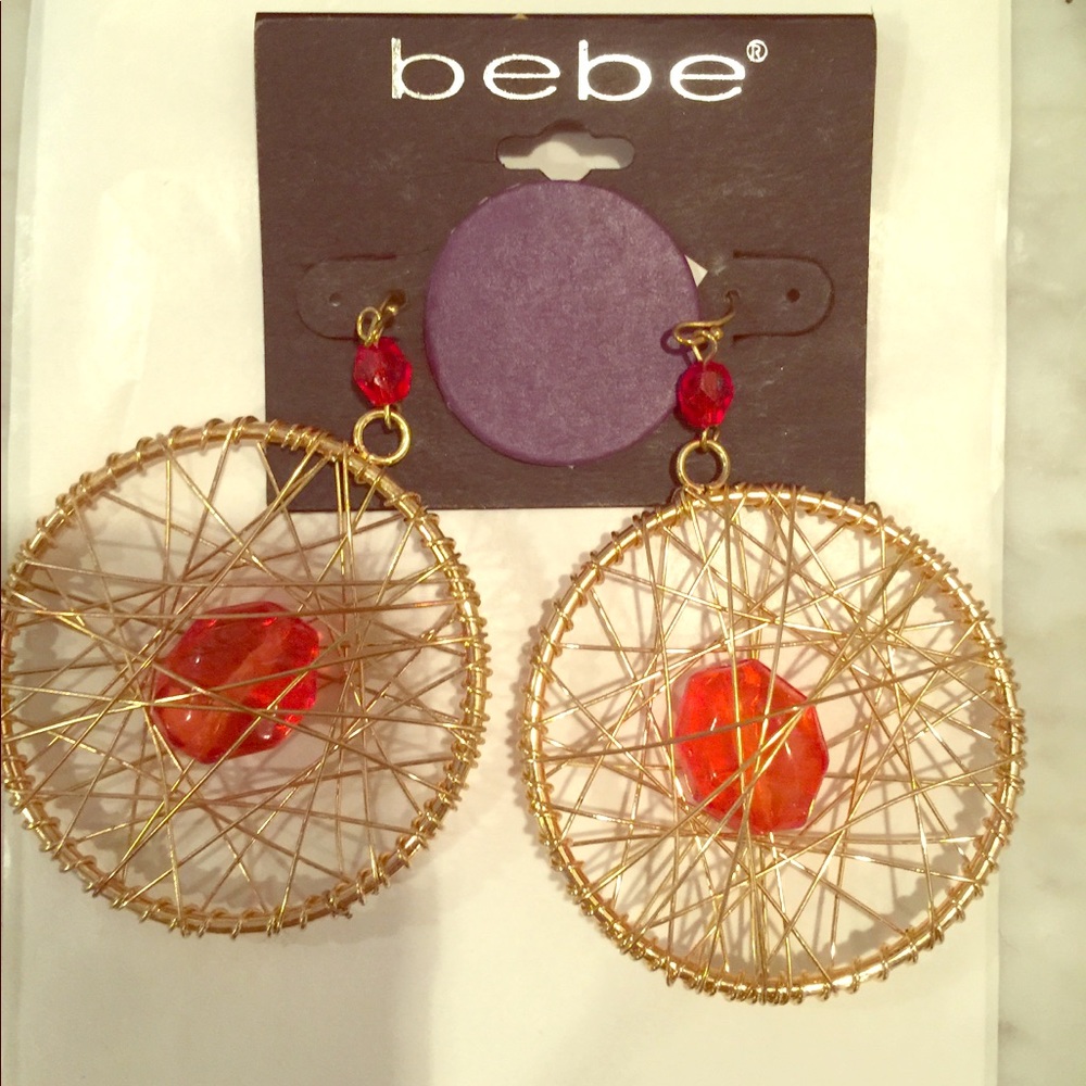 Bebe wire hoop earrings in gold.  Large orange stone inset 2” hoop